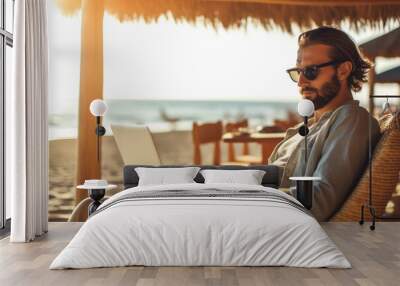 Man on the beach working as a freelancer at his computer. Generative AI Wall mural