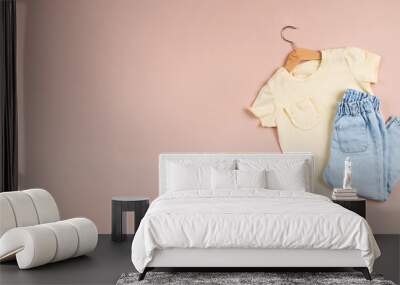 Childish image with jeans and a yellow t-shirt on a pink background. Banner. Copy space. Wall mural