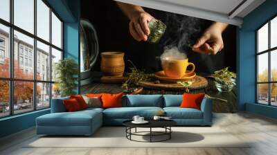 Herbalist prepares medicinal tea with mint and dry herbs in orange mug. Concept of traditional medicine at home. Wall mural