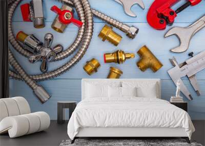 Necessary set of tools and spare parts for plumbers on blue wooden background Wall mural