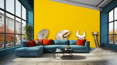 Necessary set of tools for plumbers on a yellow background. Wall mural