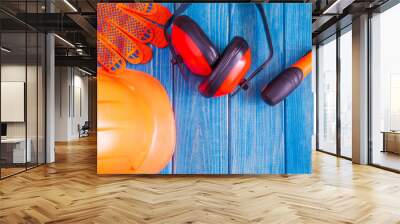 Orange hard hat and tool on wooden vintage blue boards Wall mural