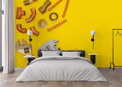 Set of tools for plumbing isolated on yellow background with space for advertising Wall mural