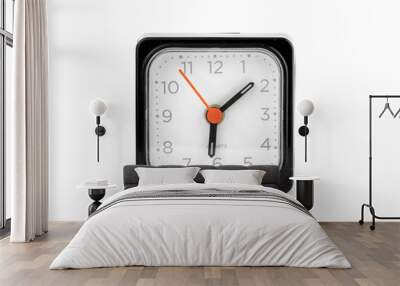 a black square clock with a red arrow facing the camera on a white background Wall mural