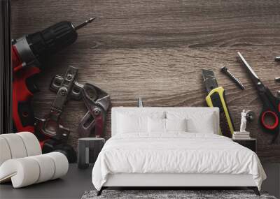 a bunch of tools designed for repair are scattered on a wooden table Wall mural