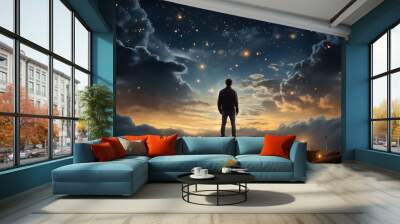 A man standing on top of a bed next to a night sky. Wall mural