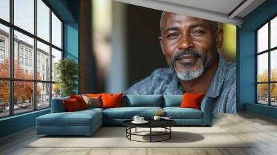 Middle-aged South African man with casual attire and a confident look. Wall mural