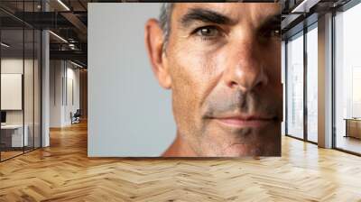 A close-up portrait of an American man with well-groomed skin, showing the texture and detail of his face Wall mural