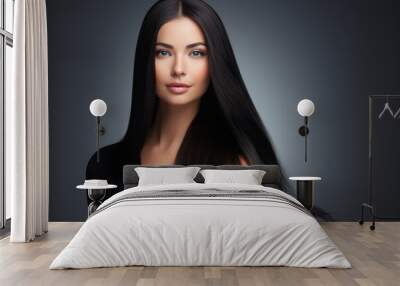 Portrait of a cute blue-eyed brunette with long well-groomed hair on a gray background. Wall mural