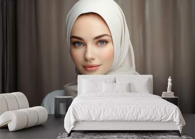 Portrait of a cute Muslim woman with blue eyes wearing a white hijab against a background of curtains. Wall mural