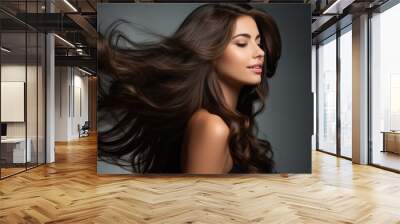 Portrait with a beautiful brown girl with gorgeous waving hair on a dark background. Wall mural