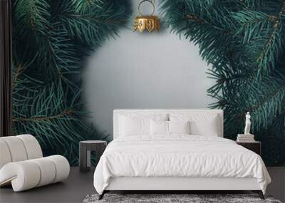 Silhouette of a Christmas ball made of pine branches. Creative Christmas layout. Wall mural