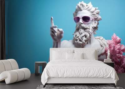 White sculpture of Poseidon wearing fancy sunglasses with pink flowers with his index finger raised up on a blue background. Wall mural