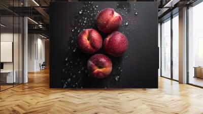 Image of a peach on a black background with water drops. Wall mural