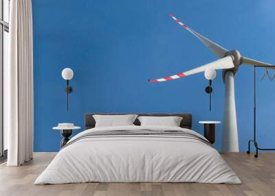 Windmill on a background of blue sky. Bottom view. Clean energy concept Wall mural