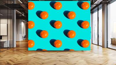 ripe tangerines on a turquoise background Wall mural