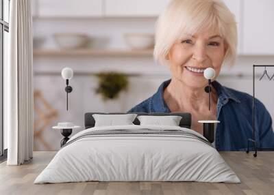 positive senior woman smiling in the kitchen Wall mural