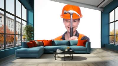 beautiful young girl worker in a helmet holds a hammer in his hand Wall mural