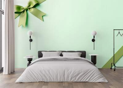 festive background a bow with a ribbon on a light green background Wall mural