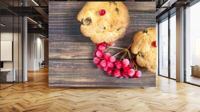 two cupcakes with red berries on a wooden table close up Wall mural