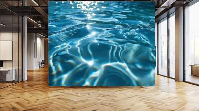 Rippling blue water reflects sunlight in a serene pool setting during midday, creating a tranquil atmosphere Wall mural