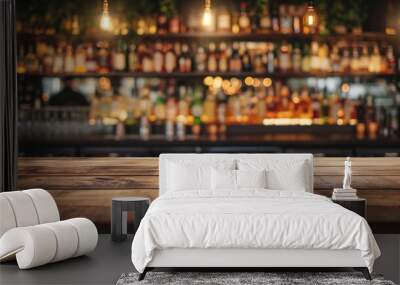 Wooden bar counter on a blurred background of bottles. Advertising space Wall mural