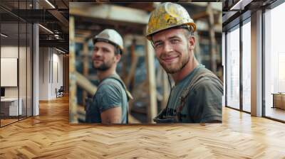 Two men wearing hard hats and work clothes are posing for a picture Wall mural