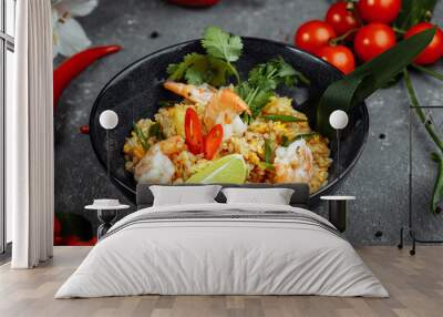 Thai rice with shrimp in a black plate on a dark background. copyright place Wall mural