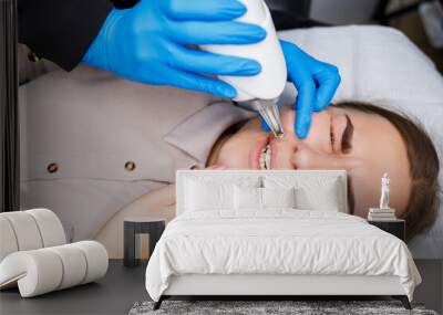 Laser removal of permanent makeup on the face. Close-up of a young woman getting tattoo correction. Correction of natural imperfections on the face. Wall mural