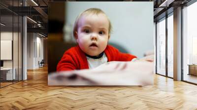 little child girl in a red sweater, her face is dirty with food, beautiful bokeh Wall mural