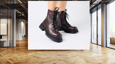 Women's brown spring boots made of genuine leather on a woman's leg. New collection of women's boots 2022 Wall mural