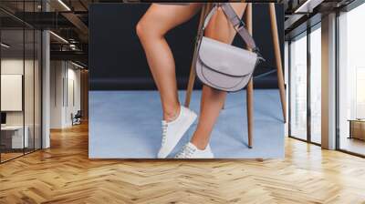 Women's legs close-up in white leather sneakers made from natural leather.Collection of women's summer shoes Wall mural