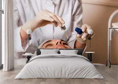 Applying a facial mask in a skin care clinic for facial skin elasticity Wall mural