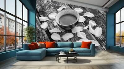 Cup of chinese tea with petals os narcissus on old wooden table Wall mural