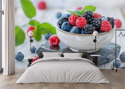 A bowl of fresh berries sitting on a wooden table, ready to be enjoyed Wall mural