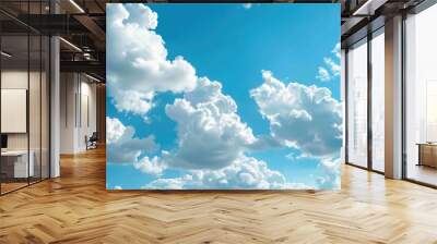 A plane soaring through the blue sky with white clouds, great for travel or adventure themes Wall mural