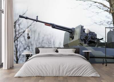 Heavy machine gun mounted on military vehicle - army military arms industry. Wall mural