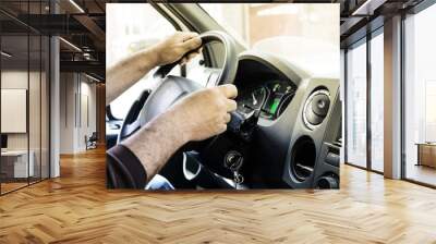 Male Mens hands on the wheel of a big car in the cabin Wall mural