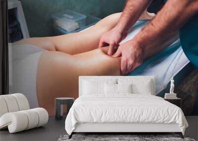 anti-cellulite massage on the legs of young women. Wall mural