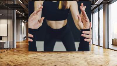 Caucasian blonde girl stretching upper body muscles with help from instructor. Wall mural