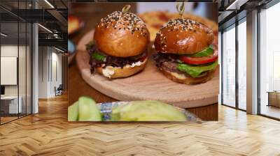 Delicious Gourmet Burgers beautifully presented on a Wooden Board at a Restaurant Wall mural