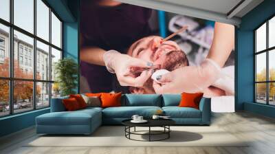 Hair removal. Man's face sugaring epilationsy ellow color, in cosmetology on the couch. hair removal inside the nose. Wall mural