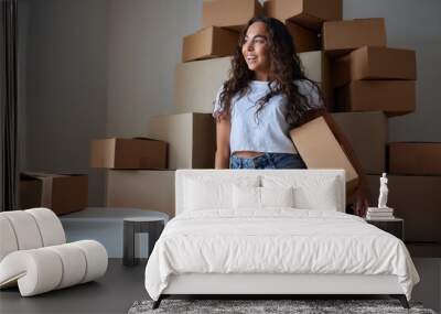 Happy woman unpacking container at home, opening carton box, looking inside package. Smiling satisfied customer receiving parcel from order delivery service, unboxing purchase. Wall mural