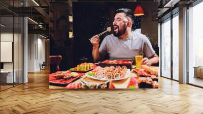 Tourist man eating asian food street local cafe, smile using chopstick. Wall mural