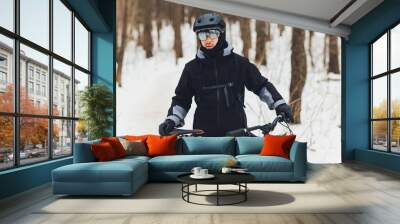 Winter riding a mountain bike in the forest. Wall mural