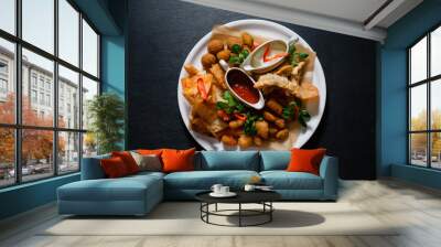 Beer snacks with nacho, grilled cheese, meat, sauce and potatoes. Wall mural