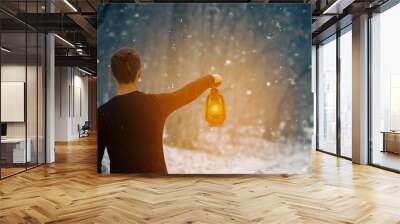 A man with a kerosene lamp in his hand walks through a snowy forest at night, a photo banner with a place for an inscription Wall mural