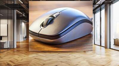 A silver computer mouse is sitting on a table Wall mural