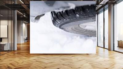 closeup of a car wheel with winter tire in snow Wall mural