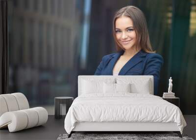 Portrait of beautiful business woman, young European gorgeous girl in suit, jacket standing outdoors with documents, papers in hands. Attractive positive office worker, lady looking at camera, smiling Wall mural